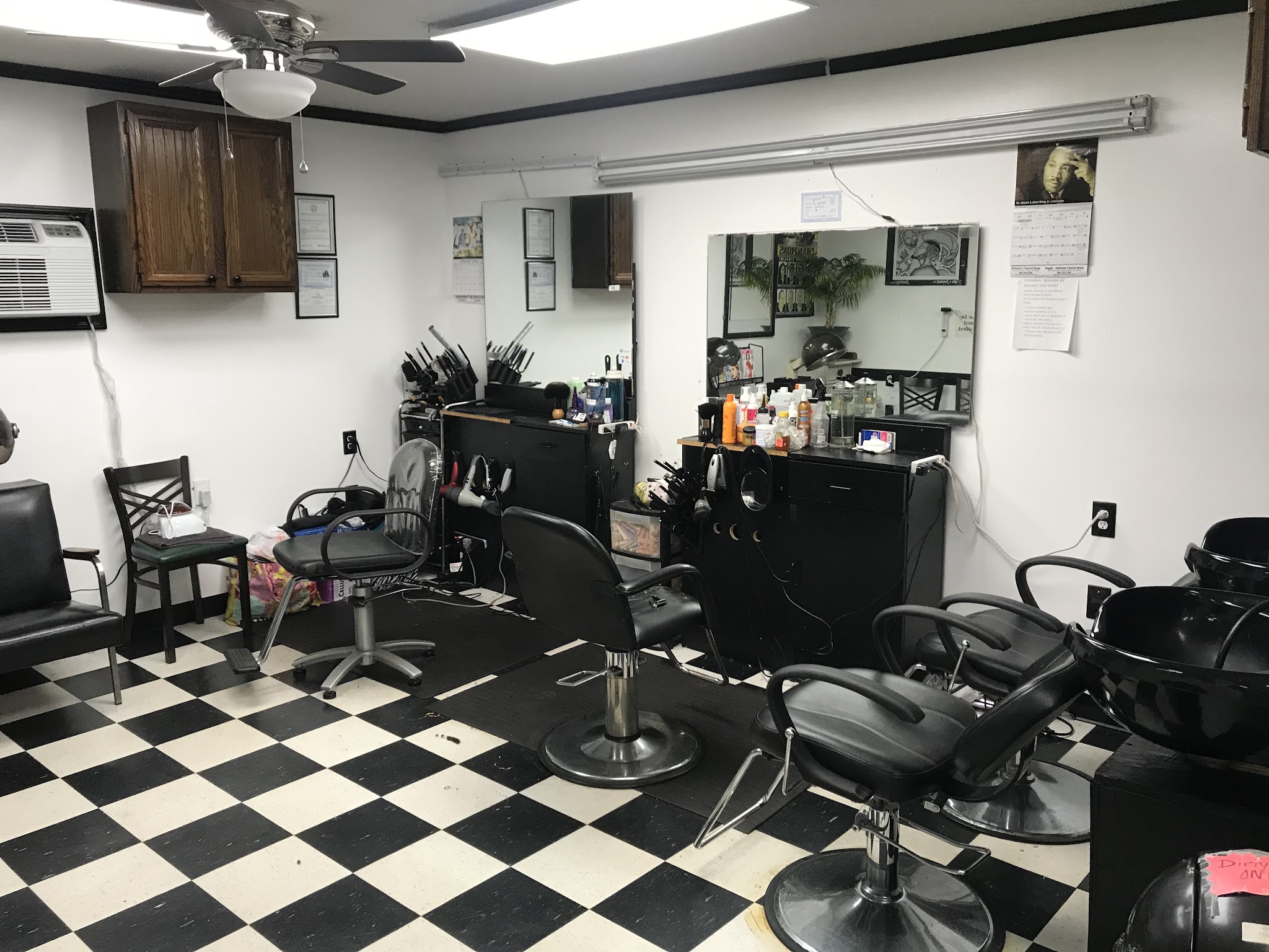 Barber chairs and mirrors on the black and white checkerboard floor