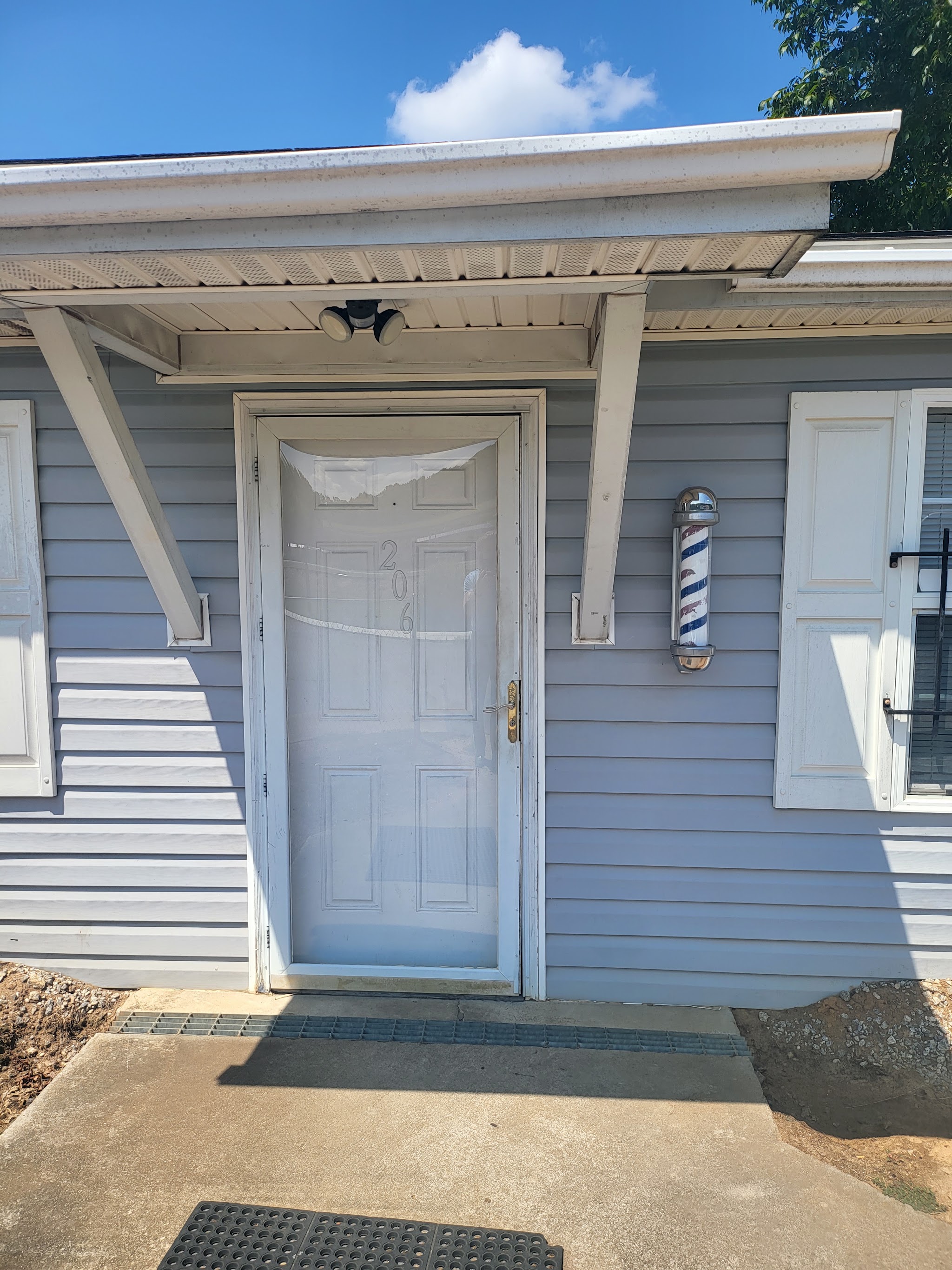 The front door at number 206 with a barber pole beside it